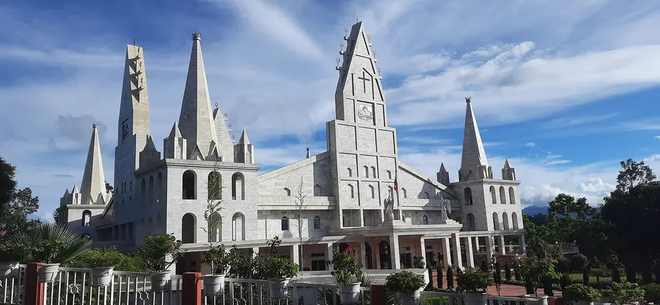 The white spires of Solomon's Temple in Aizawl against a blue sky
