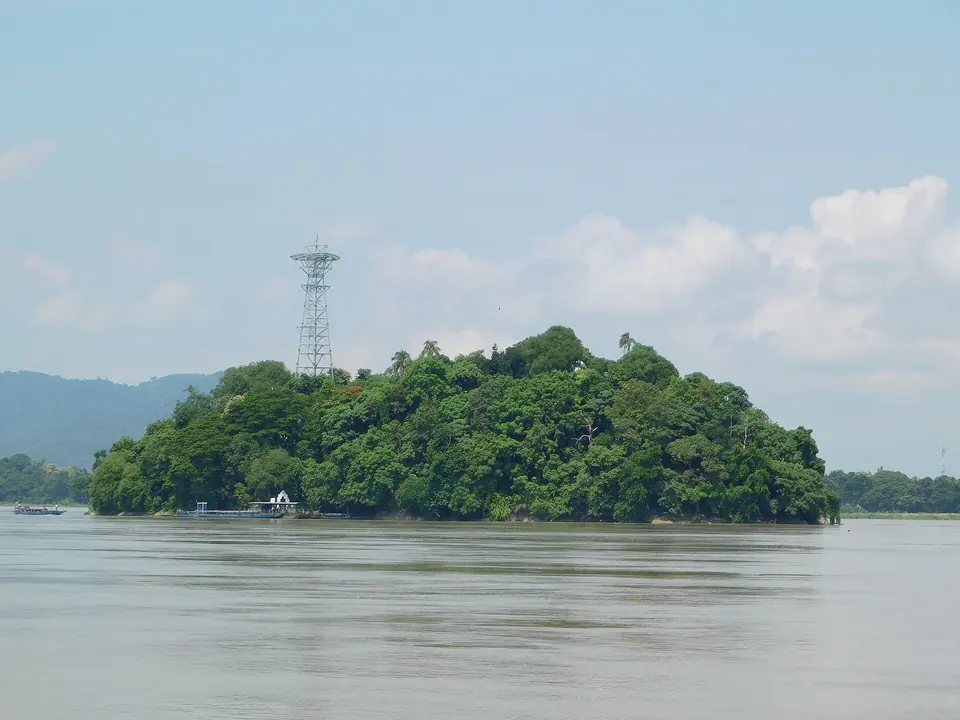 Wooded Umananda (Peacock) Island rising from the Brahmaputra, seen from Umananda Ghat in Guwahati