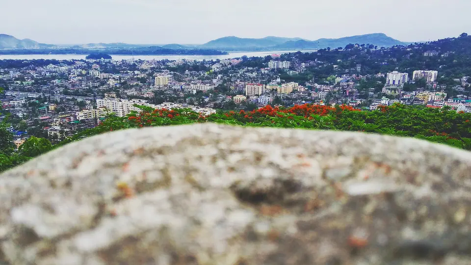 Guwahati's buildings spreading to the Brahmaputra and blue hills, seen from Sarania Hill