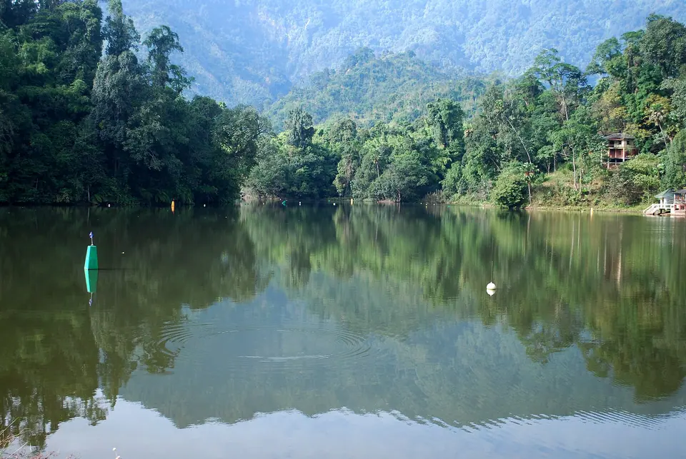 Forested hills reflected in the still green water of Gyakar Sinyi (Ganga Lake) near Itanagar