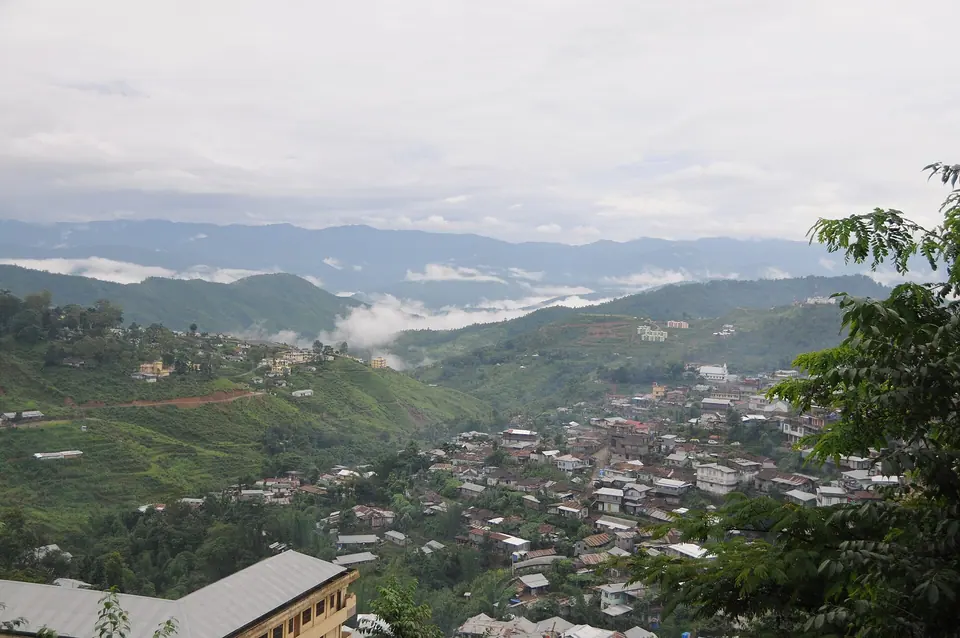 Kohima's houses spilling down green ridges with clouds lying in the valleys beyond, Nagaland