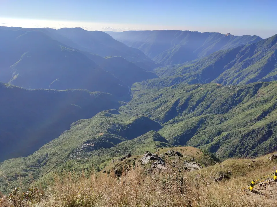 Deep green gorges of Laitlum Canyon falling away from a grassy ridge edge, East Khasi Hills