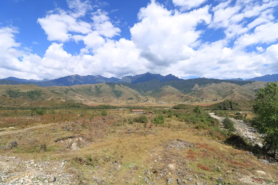 Big white clouds over the golden meadows and ridges surrounding Mechuka, 1,900 m