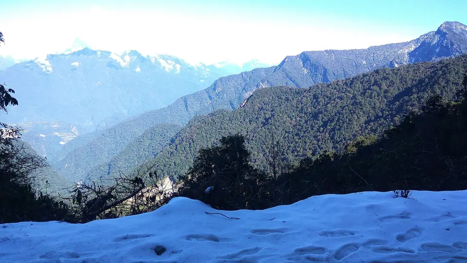 Fresh snow at Mayodia Pass, 2,655 m, with blue Mishmi Hills folding away below