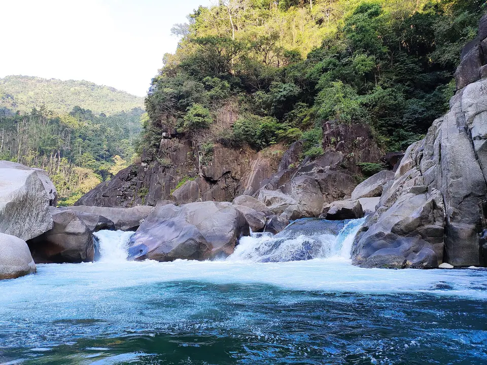 White water tumbling between granite boulders beside the Umngot River in the Dawki area