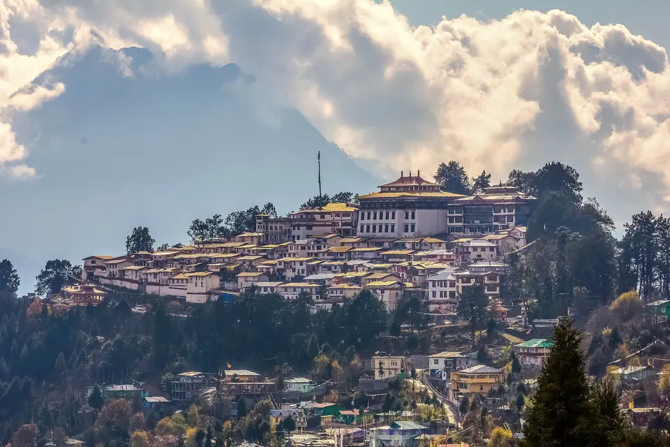 Tawang town and its hilltop monastery under towering white clouds, Arunachal Pradesh