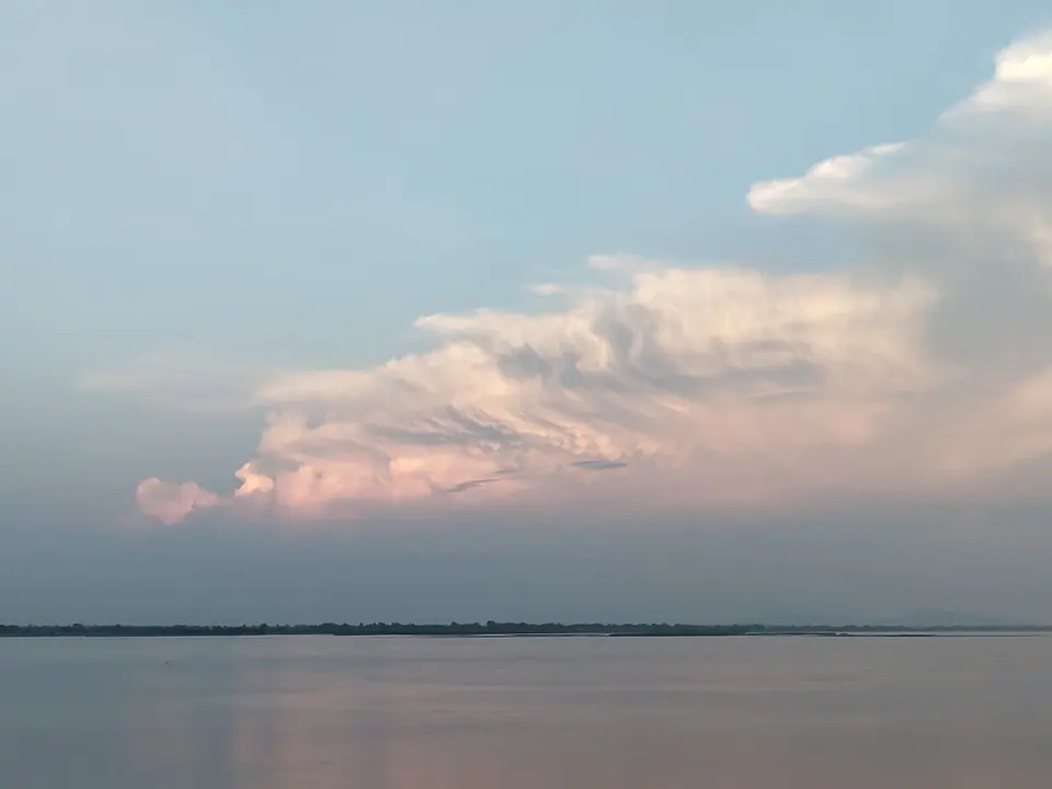 Pink evening clouds over the broad, calm Brahmaputra at Tezpur